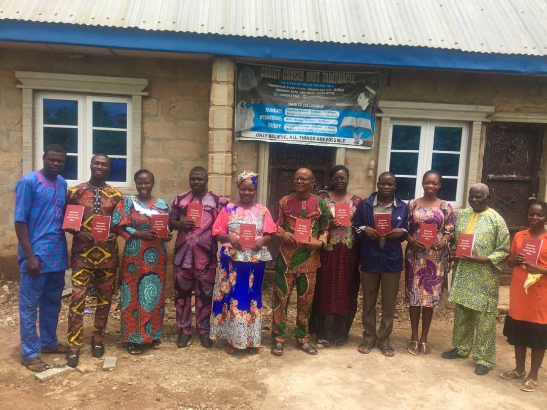 Believers in Nigeria receiving Seven Church Age books printed in Yoruba.