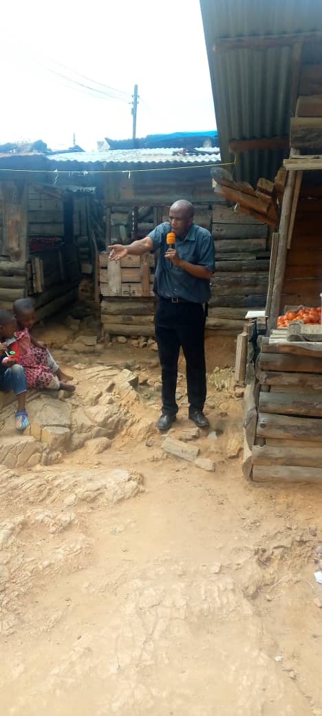 Bro. Isaac preaching at the market place